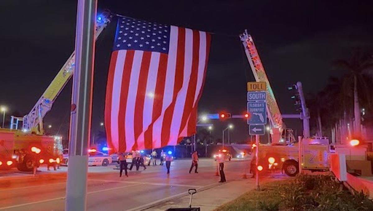 Miami-Dade Fire Rescue firefighters raise an American flag on Friday, Nov. 7, 2025, at HCA Florida Kendall Hospital.