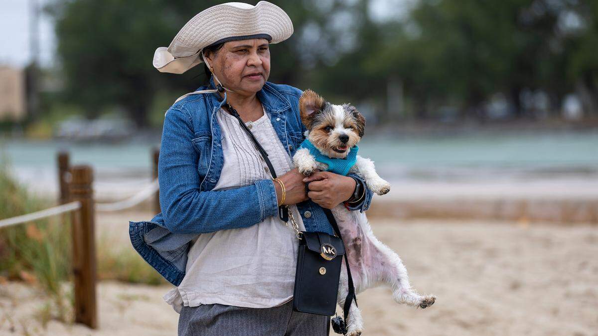 Devika Persad holds his 1-year-old Yorkshire Terrier Tucker at the Bal Harbour Lighthouse on Tuesday, Nov. 5, 2024, in Bal Harbour, Fla. There was a wind advisory that day. On the weekend of Nov. 15-16 no wind worries. Rather, a cold front could bring lows to the upper 60s for parts of South Florida.