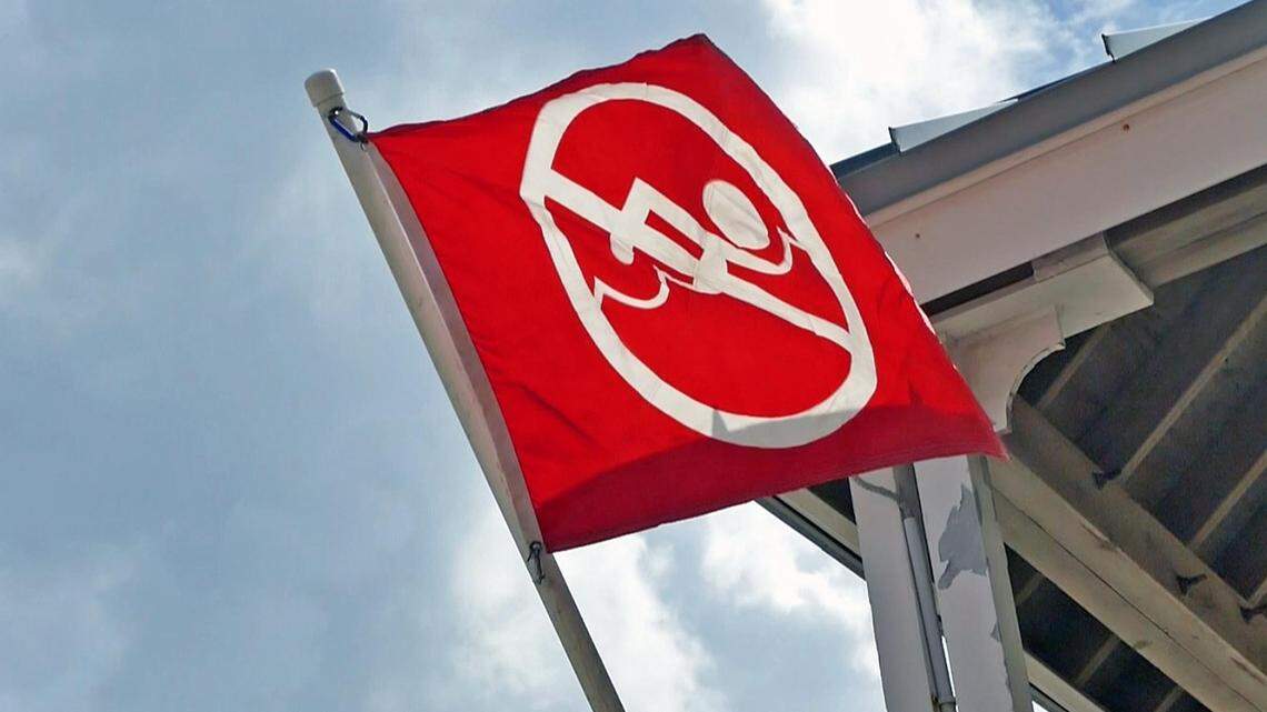 The red flags flying at the lifeguard station on North Crandon Beach in Key Biscayne means that beach is closed.