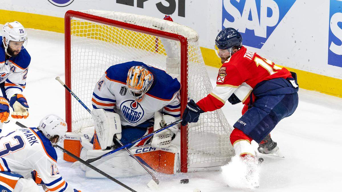 Edmonton Oilers defenseman Darnell Nurse (25) and Oilers center Mattias Janmark (13) helps Oilers goaltender Stuart Skinner (74) defend the net against pressure from the Florida Panthers left wing Matthew Tkachuk (19) during the seconds period of Game 5 of the NHL Stanley Cup Final at the Amerant Bank Arena on Tuesday, June 18, 2024, in Sunrise, Fla.