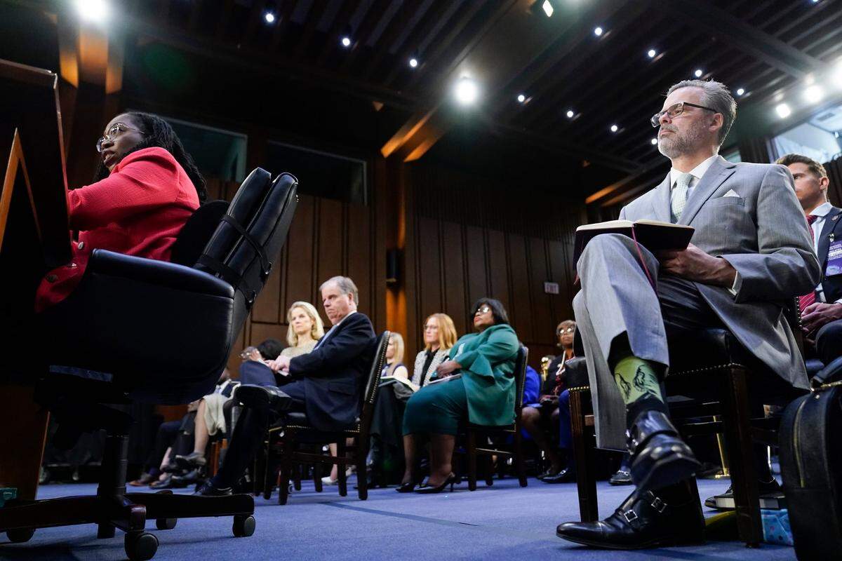 Supreme Court nominee Ketanji Brown Jackson testifies during her Senate Judiciary Committee confirmation hearing on Capitol Hill in Washington, Tuesday, March 22, 2022. Judge Jackson’s husband, Dr. Patrick Jackson, right, looks on.