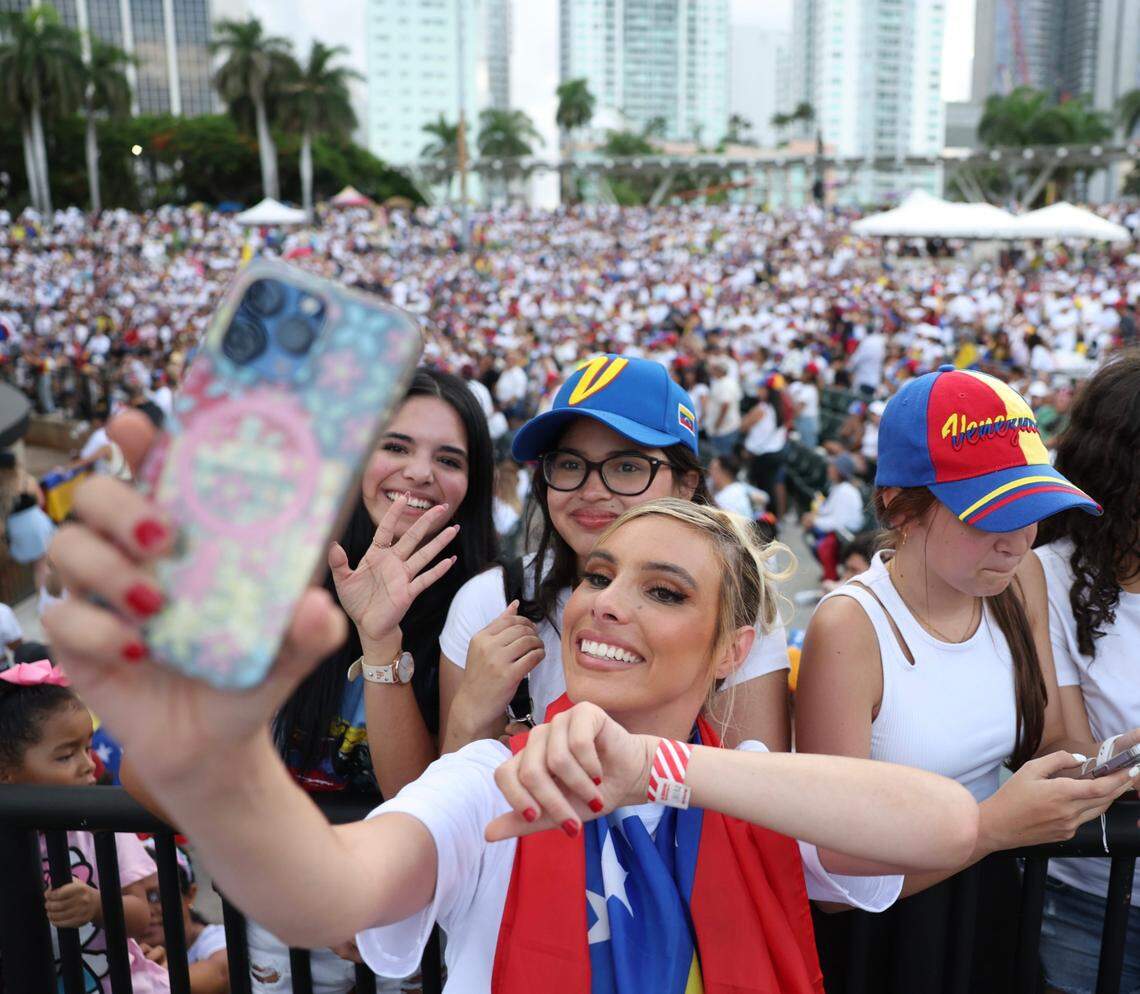 Venezuelan YouTuber and actress, Lele Pons, foreground, shoots selfies with fans in the crowd during the rally in downtown Miami.