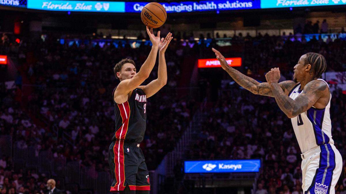 Miami Heat guard Pelle Larsson (9) shoots a three-pointer over Sacramento Kings forward DeMar DeRozan (10) during an NBA game at Kaseya Center on November 4, 2024, in Miami.