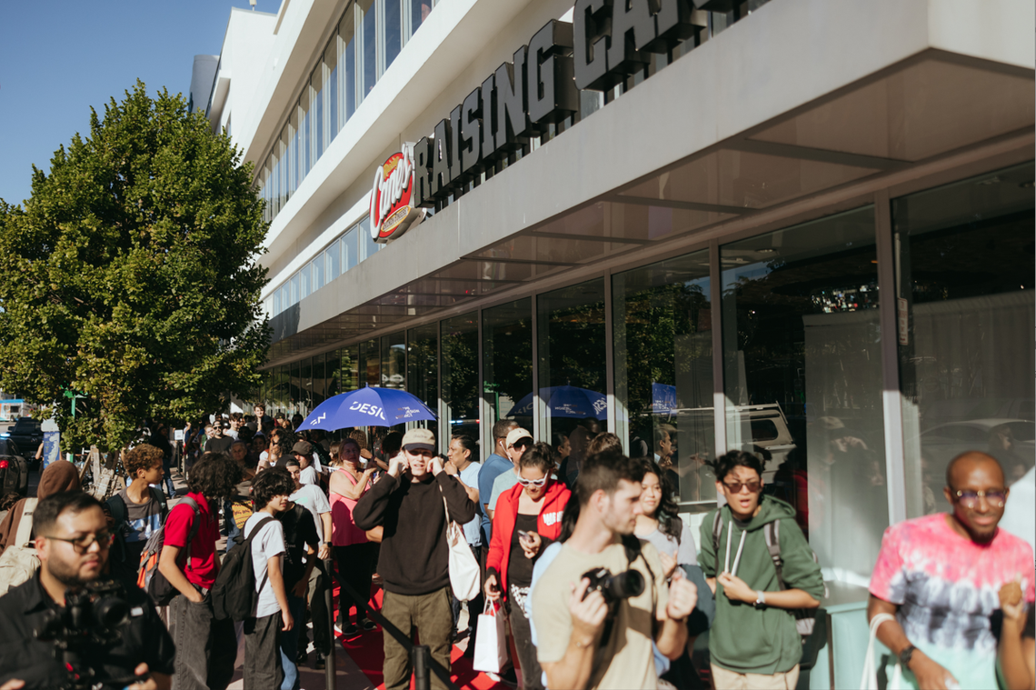 Raising Cane’s opened its second location in South Florida in Miami Beach. Above: A photo of customers waiting to go inside the fast-food chain’s South Beach eatery.
