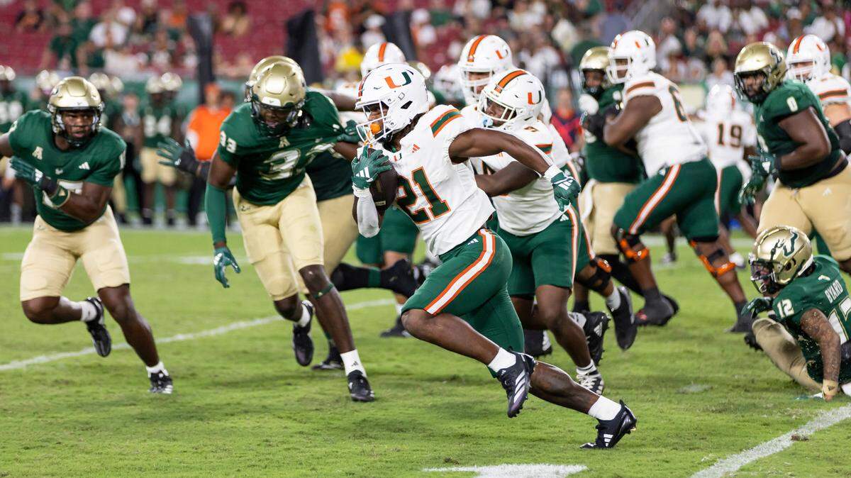 Miami Hurricanes running back Jordan Lyle (21) runs with the ball to score a touchdown against the South Florida Bulls in the second half of their NCAA college football game at the Raymond James Stadium on Saturday, Sept. 21, 2024, in Tampa, Fla.