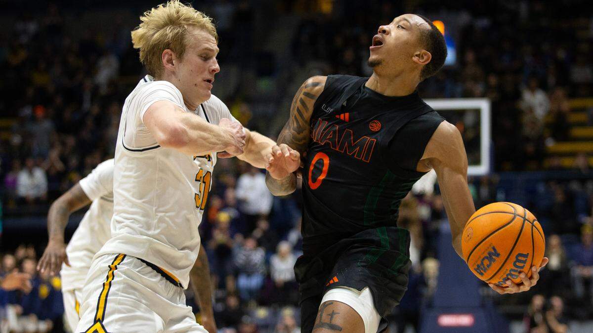 Jan 25, 2025; Berkeley, California, USA; Miami Hurricanes guard Matthew Cleveland (0) drives against California Golden Bears forward Rytis Petraitis (31) during the second half at Haas Pavilion. Mandatory Credit: D. Ross Cameron-Imagn Images