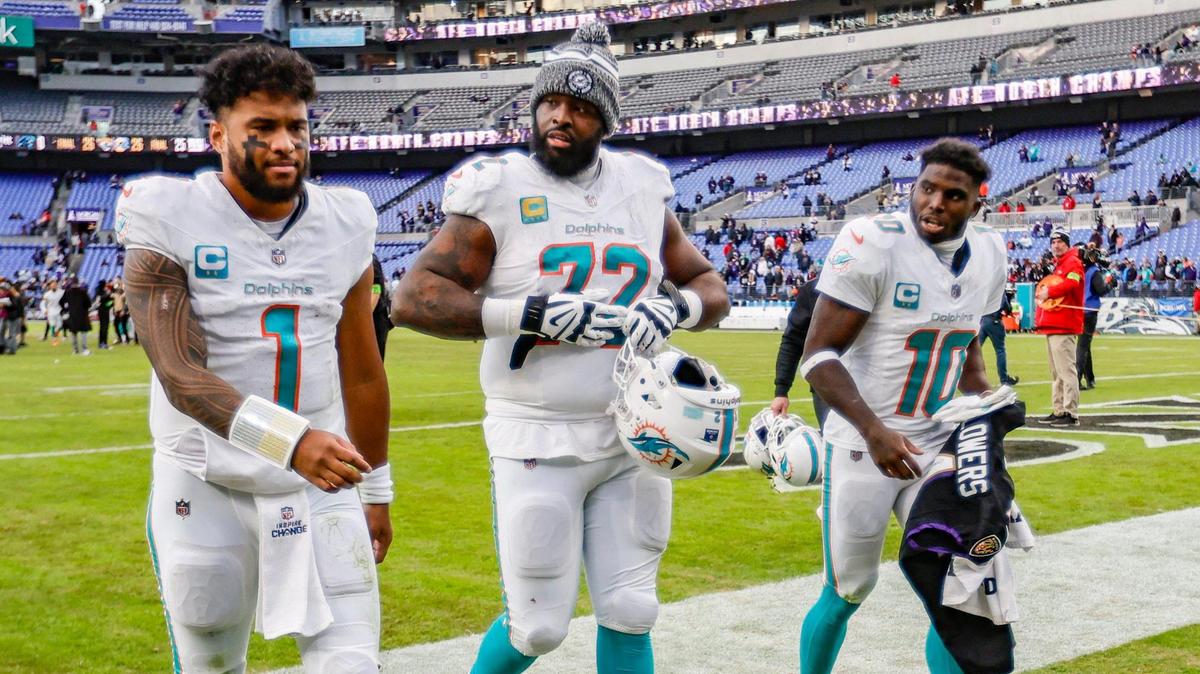 Miami Dolphins quarterback Tua Tagovailoa (1) walks off the field with teammates offensive tackle Terron Armstead (72) and wide receiver Tyreek Hill (10) after the loss against the Baltimore Ravens at M&T Bank Stadium in Baltimore, Maryland on Sunday, December 31, 2023.
