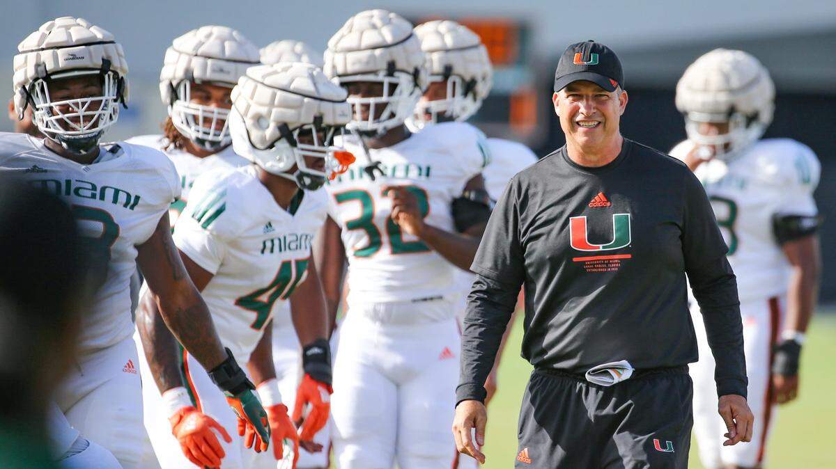 Miami Hurricanes Mario Cristobal watches over his players during practice drills at Greentree Practice Field at the University of Miami in Coral Gables on Thursday, August 11, 2022.