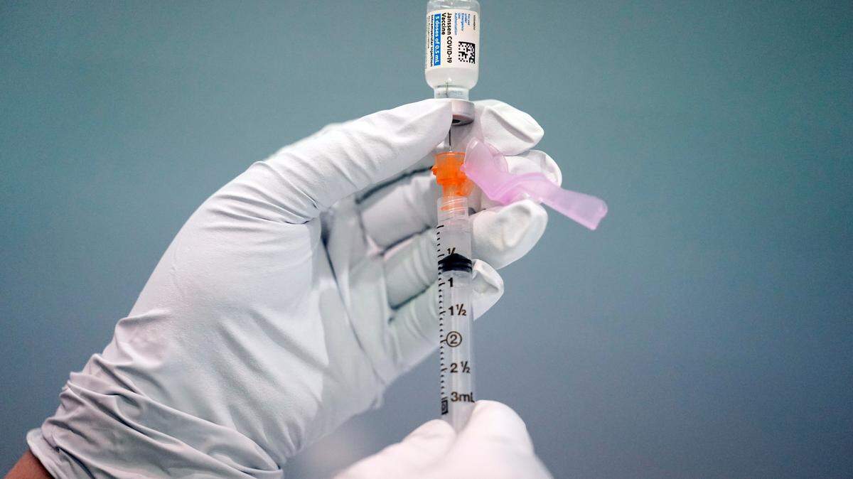 FILE - In this March 26, 2021, file photo, a member of the Philadelphia Fire Department prepares a dose of the Johnson & Johnson COVID-19 vaccine at a vaccination site setup at a Salvation Army location in Philadelphia.