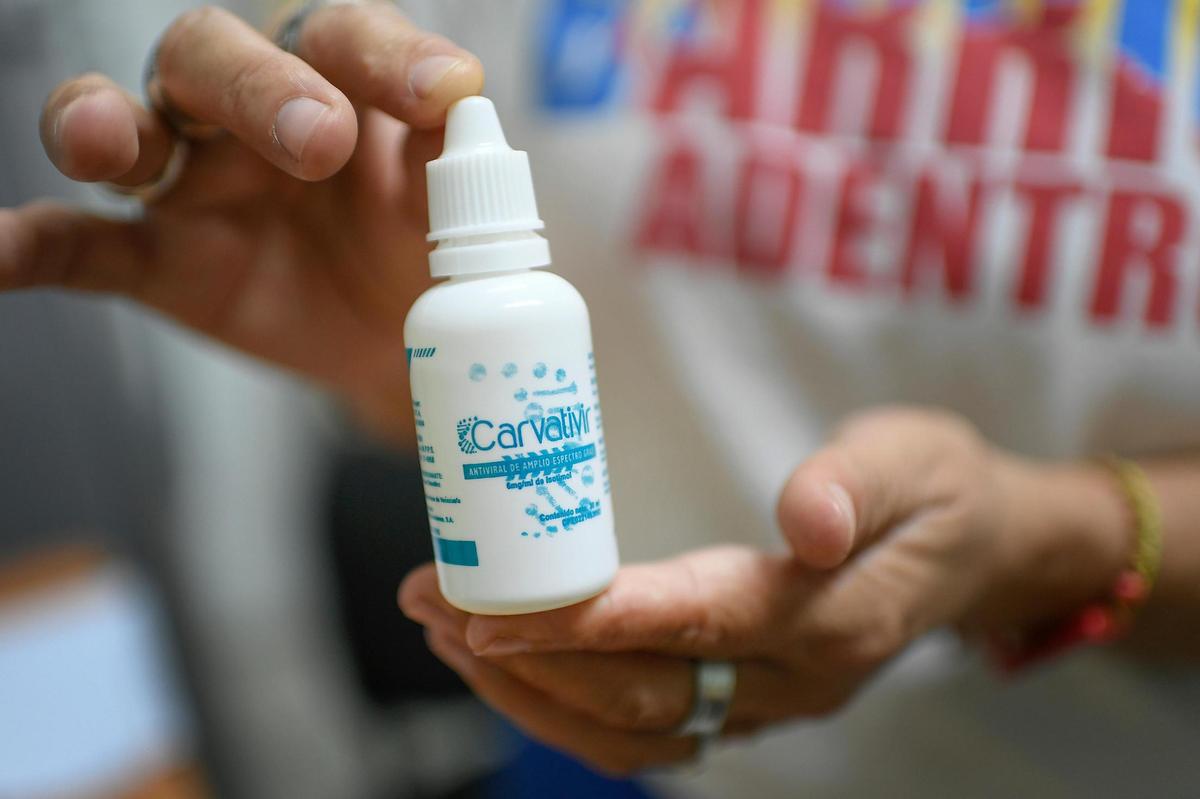 A nurse holds a bottle of Carvativir at a health center of the Barrio Adentro government health clinic in the El Paraiso neighborhood of Caracas, Venezuela, on March 25, 2021. Developed by Venezuelan scientists, authorities say it is an antiviral solution that reduces the symptoms caused by COVID-19, leading to a quicker recovery.