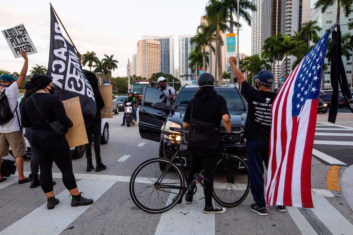 Protestors hold up traffic on Biscayne Boulevard and NE 3rd Street during a protest by South Florida activists, to get justice for Ma’khia Bryant, who was killed by police in Columbus, Ohio, at the Simon Bolivar Monument in Downtown Miami, Florida, on Saturday, April 24, 2021.