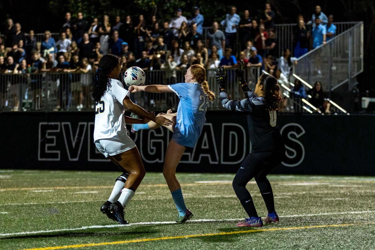 Ransom Everglades attacker Charlie Jaffee (25) scores the finalizer over Palmer Trinity defender Maya Vanzant (25) and keeper Valentina Herrera (0) during the girls soccer 4-2A Regional Final on Wednesday, February 19, 2025, in Coconut Grove, Florida.