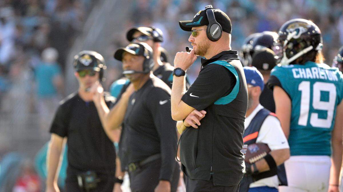 Jacksonville Jaguars interim head coach Darrell Bevell, front, watches from the sideline during the second half of an NFL football game against the Indianapolis Colts, Sunday, Jan. 9, 2022, in Jacksonville, Fla. (AP Photo/Phelan M. Ebenhack)