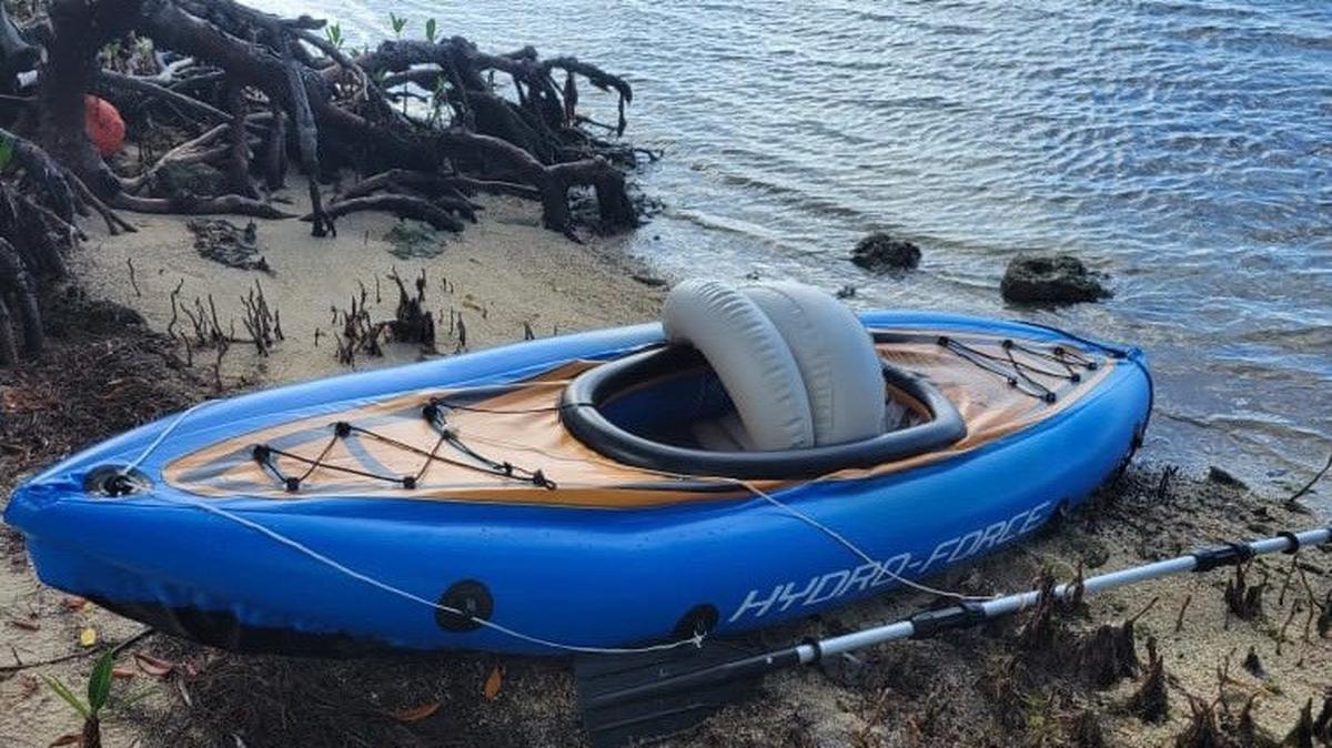 A blue kayak is beached on the shore of the Middle Florida Keys city of Marathon Sunday, Aug. 22, 2022. The Border Patrol says the vessel was used by a Cuban migrant to reach South Florida.