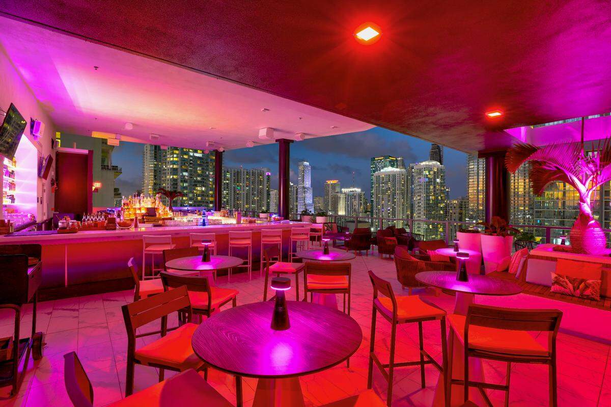 Neon lights illuminate Rosa Sky rooftop bar in downtown Miami.