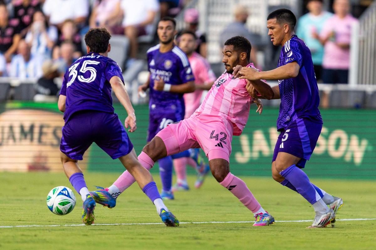 Inter Miami midfielder Yannick Bright (42) passes the ball while defended by Orlando City midfielder César Araújo (5) and midfielder Joran Gerbet (35) during the first half of an MLS match at Chase Stadium on Sunday, May 18, 2025, in Fort Lauderdale, Fla.