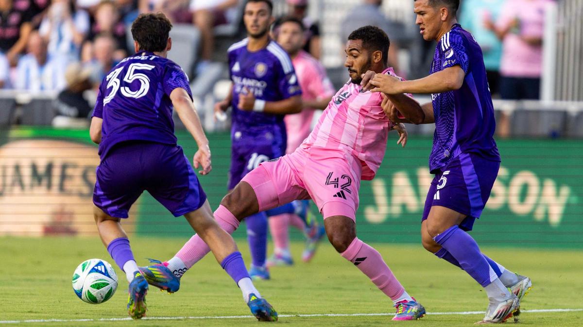 Inter Miami midfielder Yannick Bright (42) passes the ball while defended by Orlando City midfielder César Araújo (5) and midfielder Joran Gerbet (35) during the first half of an MLS match at Chase Stadium on Sunday, May 18, 2025, in Fort Lauderdale, Fla.