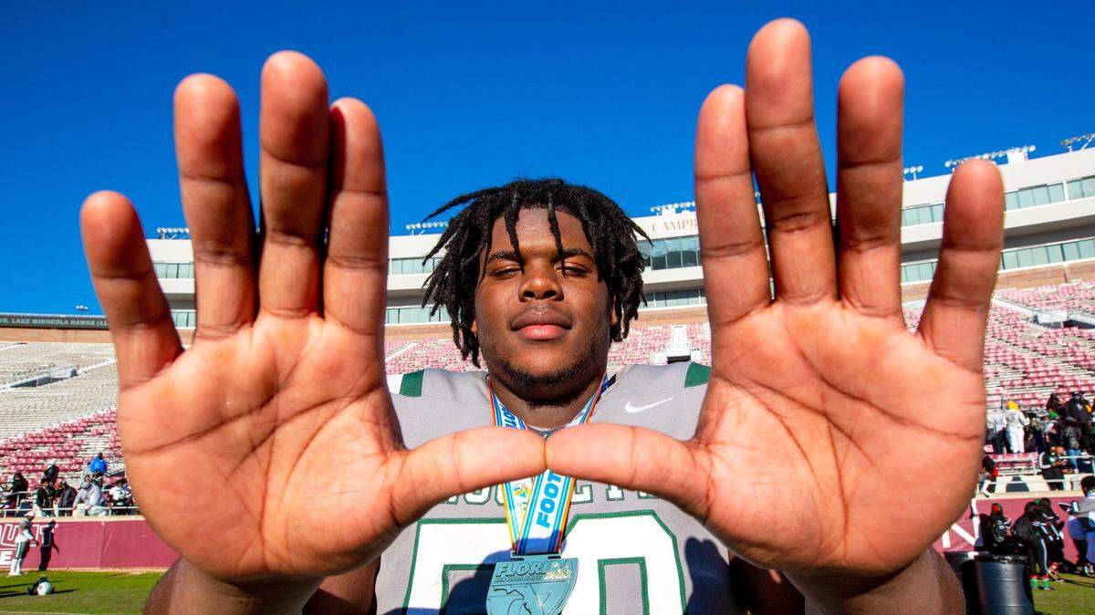 Miami Central guard and University of Miami signee Laurence Seymore (50) celebrates by throwing up ‘The U’ after defeating Lake Minneola 46-0 at Doak Campbell Stadium in Tallahassee, Florida, on Friday, December 18, 2020.