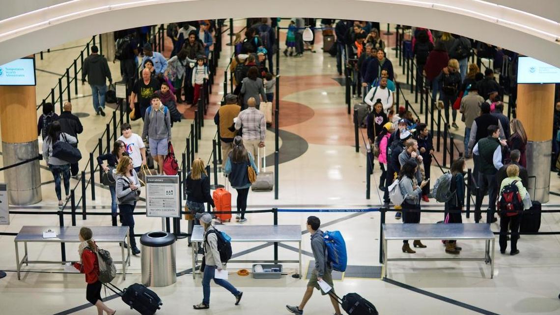 Travelers wait to go through a security checkpoint at Hartsfield- Jackson Atlanta International Airport in Atlanta.