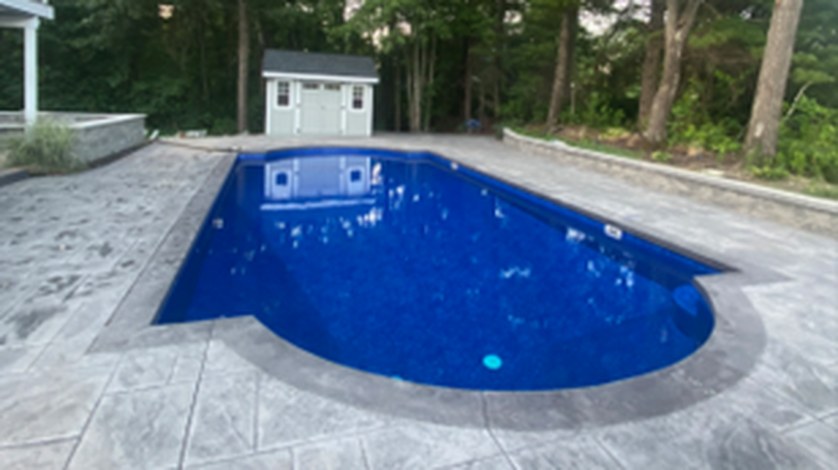 A former U.S. postal inspector from Massachusetts is charged with stealing more than $330,000 and using the money for personal expenses, including a pool patio, according to federal prosecutors.
