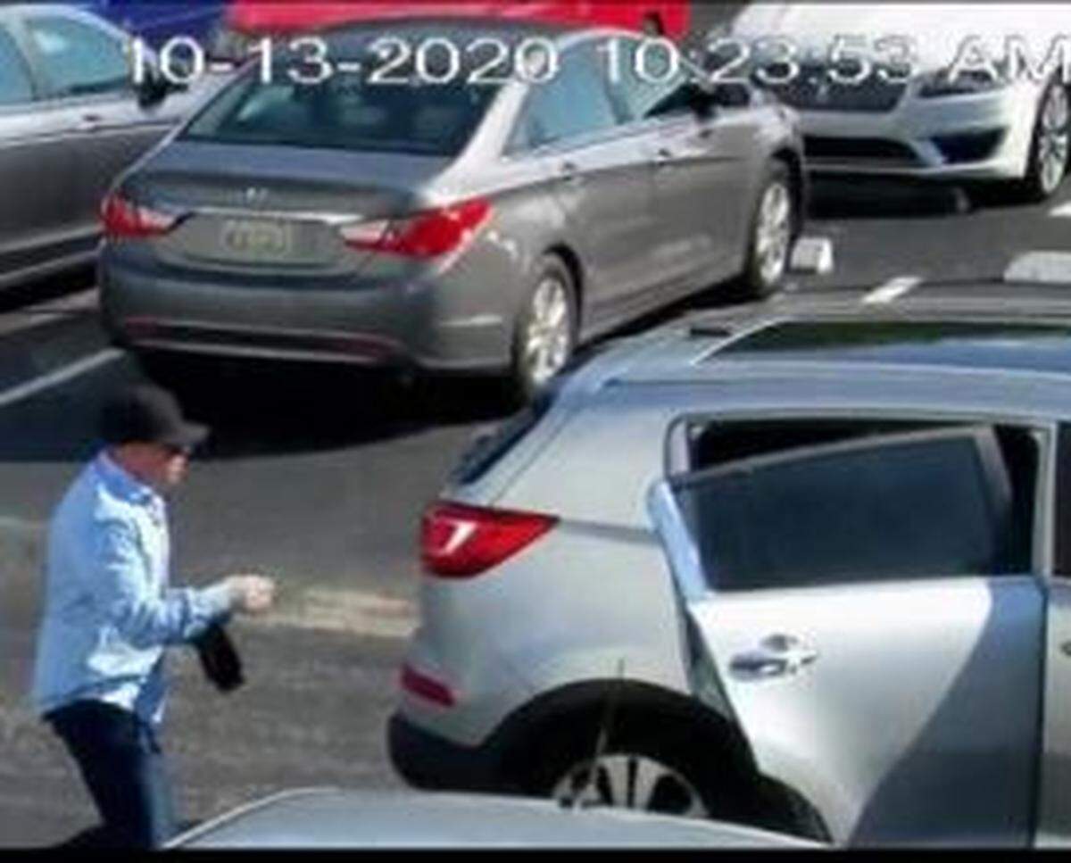 One of the would-be armed robbers jumps in the Kia Sportage to leave the Castle Apartments’ parking lot.
