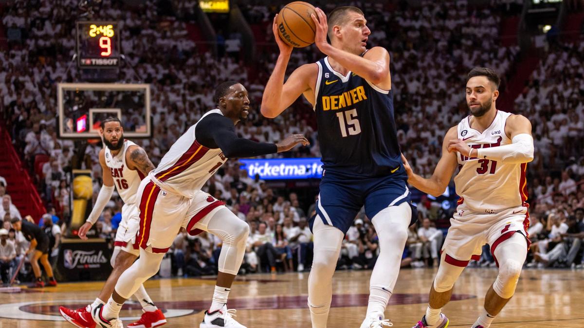 Denver Nuggets center Nikola Jokic (15) looks to pass while defended by Miami Heat forward Max Strus (31) during the first half of Game 4 of the NBA Finals at the Kaseya Center on Friday, June 9, 2023, in downtown Miami, Fla.