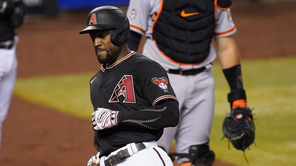 Arizona Diamondbacks’ Starling Marte scores on a base hit by teammate Christian Walker during the fifth inning of a baseball game against the San Francisco Giants, Friday, Aug. 28, 2020, in Phoenix.