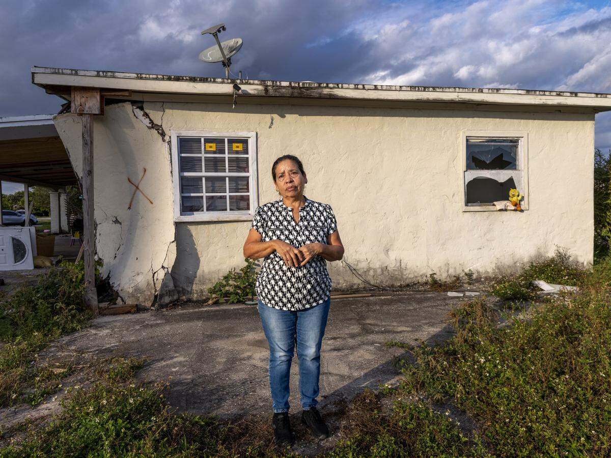 Lucía Cruz, who left her home in September, has moved in with her daughter’s family. She stands near one of the few remaining mobile homes at Li’l Abner that are waiting to be demolished on Sunday, Dec. 21, 2025, in Sweetwater, Florida.