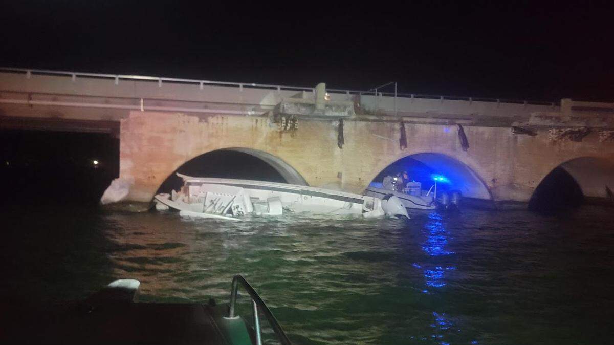 A badly damaged Sea Hunter center console lists on its side after it hit the South Pine Channel Bridge in the Lower Florida Keys around 2 a.m. Monday, July 8, 2024. First responders and a boat towing company performed a heroic rescue to remove the injured before the boat sank.