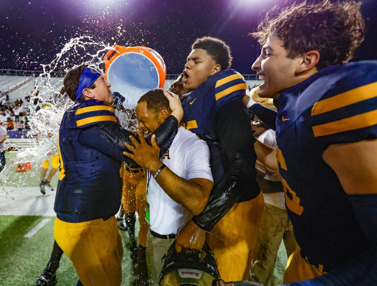 St. Thomas Aquinas coach Roger Harriott gets splashed after Raiders defeat the Homestead Broncos in the Class 3M state championships at Bragg Memorial Stadium in Tallahassee, Florida on Saturday, December 9, 2023.
