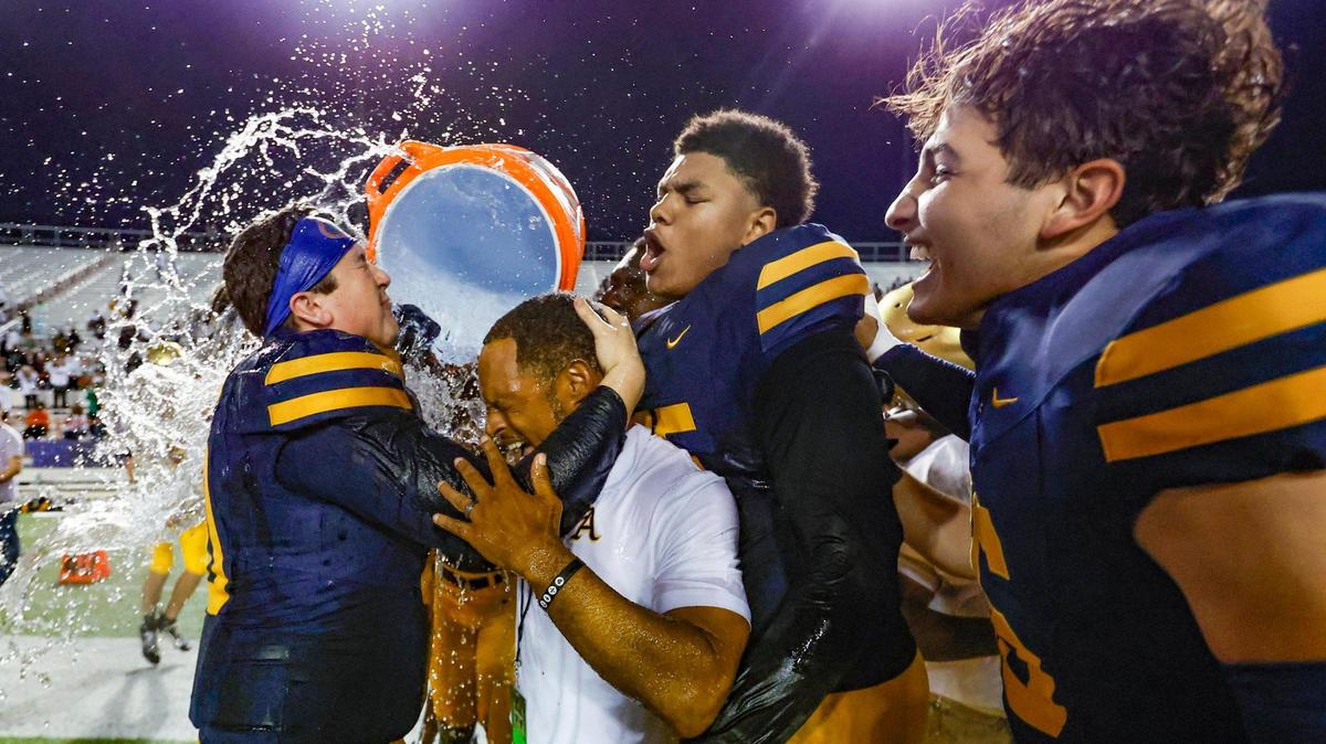 St. Thomas Aquinas coach Roger Harriott gets splashed after Raiders defeat the Homestead Broncos in the Class 3M state championships at Bragg Memorial Stadium in Tallahassee, Florida on Saturday, December 9, 2023.