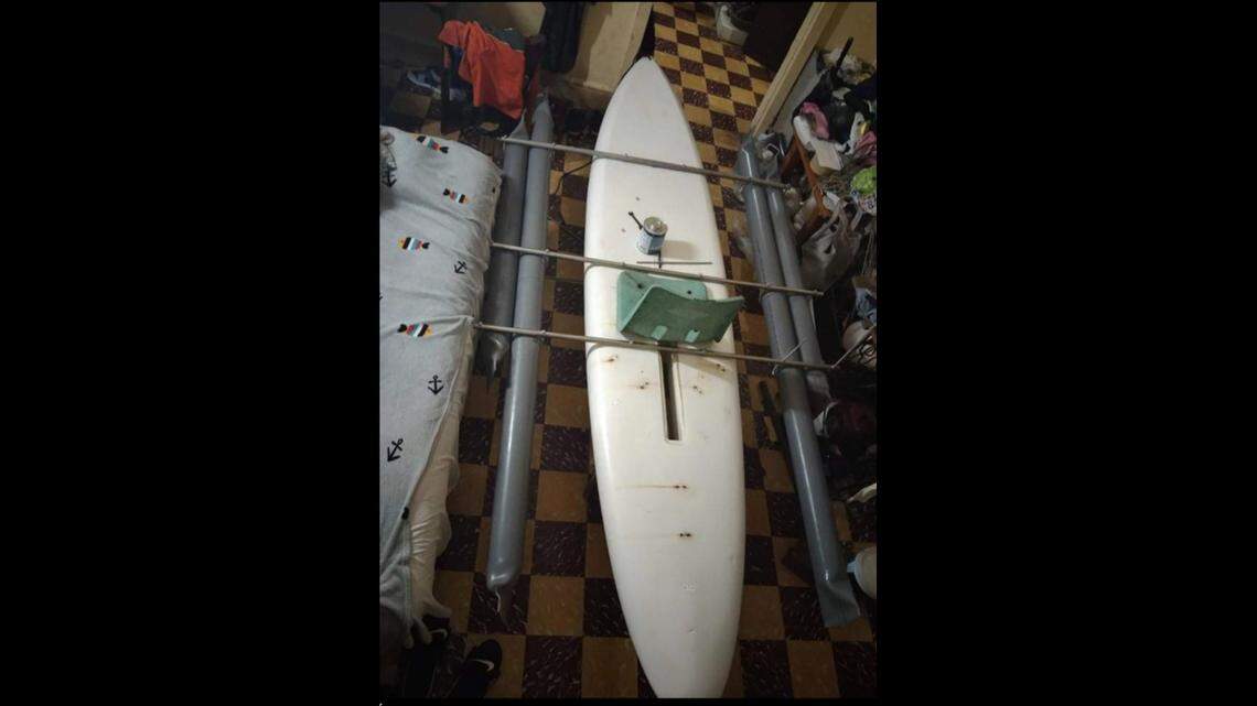 A surfboard attached to pontoons is seen in a room in Cuba. The Coast Guard said Monday, March 28, 2022, that two men left Cuba on the homemade vessel days earlier and have not been seen or heard from since.