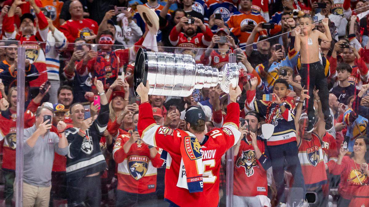 Florida Panthers center Aleksander Barkov (16) holds the Stanley Cup as fans cheer after defeating the Edmonton Oilers in Game 7 of the Stanley Cup Final at Amerant Bank Arena on Monday, June 24, 2024, in Sunrise, Fla.