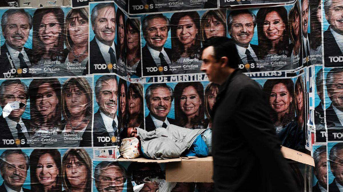 A homeless man in Buenos Aires, Argentina, sleeps under posters of newly elected president Alberto Fernandez and his running mate Cristina Fernández de Kirchner last year.
