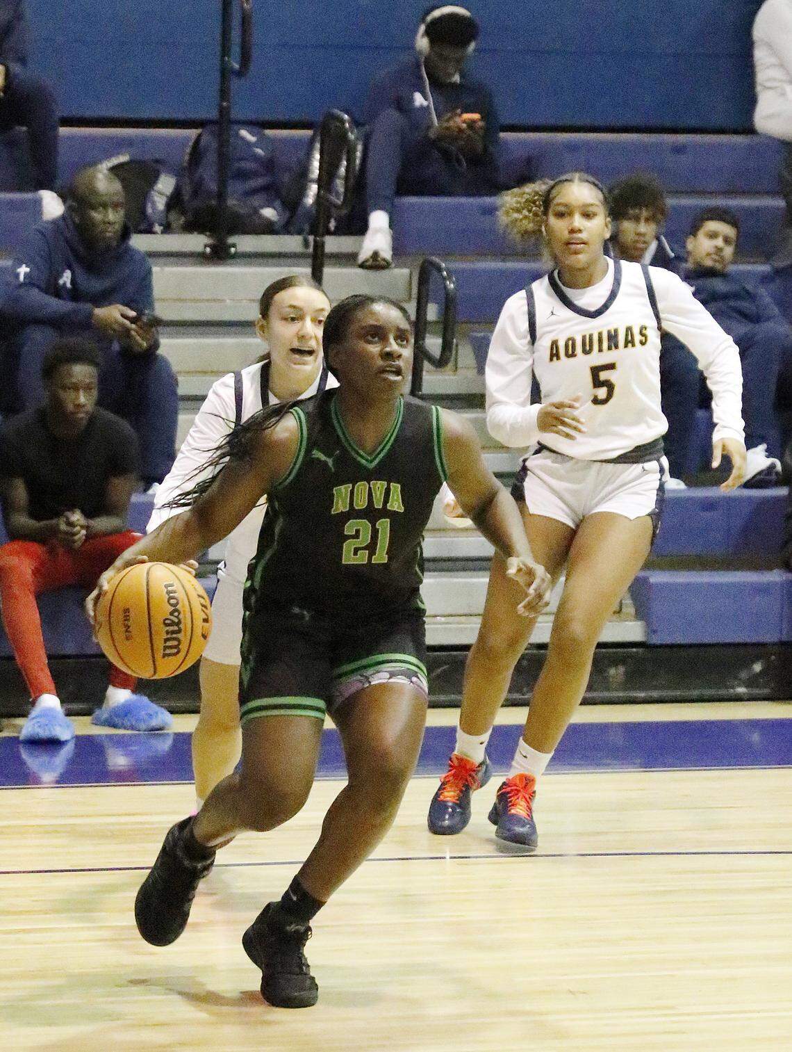 Nova Lady Titans Ya'Niyah Young (21) controls the ball during the BCAA Big 8 girls basketball tournament final game against St. Thomas Aquinas Raiders on Saturday, January 31, 2026 at Fort Lauderdale HS in Fort Lauderdale. Andrew Uloza / for Miami Herald