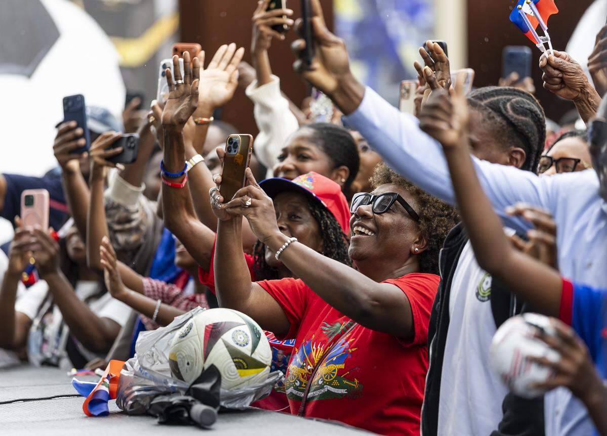 Fans react as the Haiti national soccer team arrives for a meet-and-greet at the Museum of Contemporary Art.