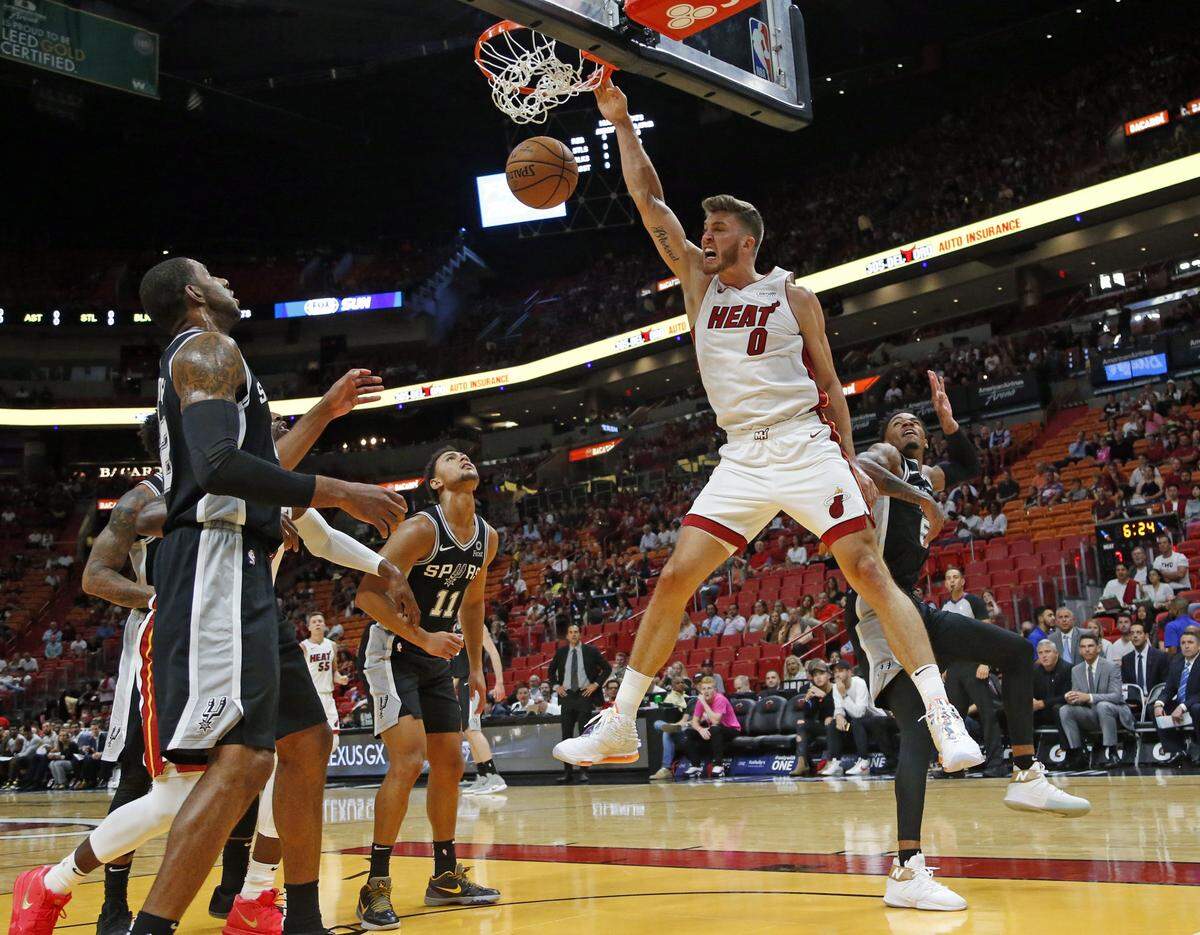 Heat forward Meyers Leonard (0) dunks the ball in the first quarter as the Heat hosts the Spurs at the American Airlines Arena on Oct. 8, 2019.