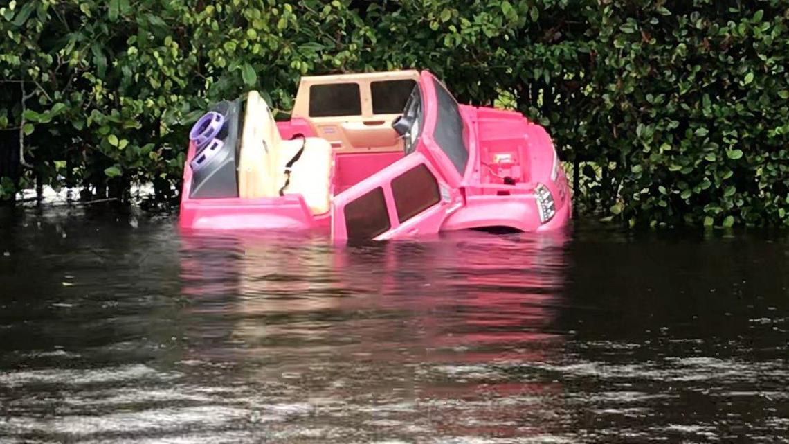 A plastic toy car is washed up along the side of a flooded road near 67th Avenue near Hialeah on November 10, 2020.