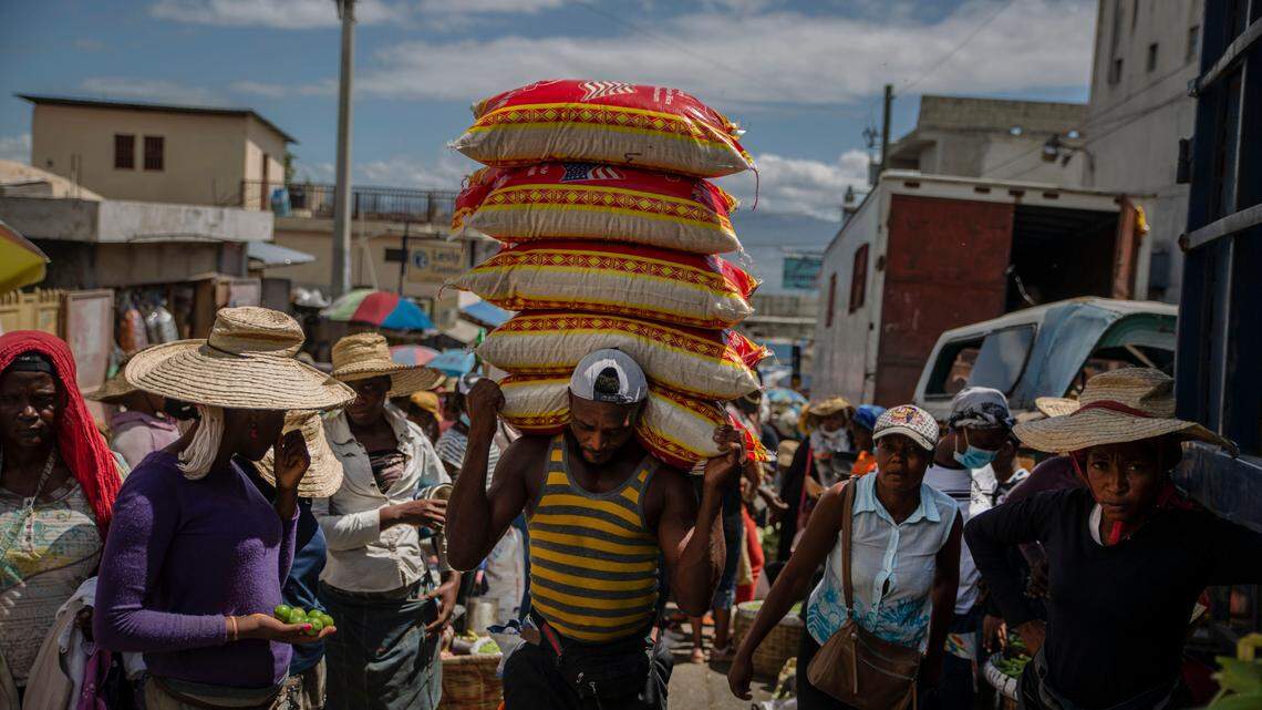 A man carries goods at a street market in Port-au-Prince, Haiti, Saturday, June 5, 2021.