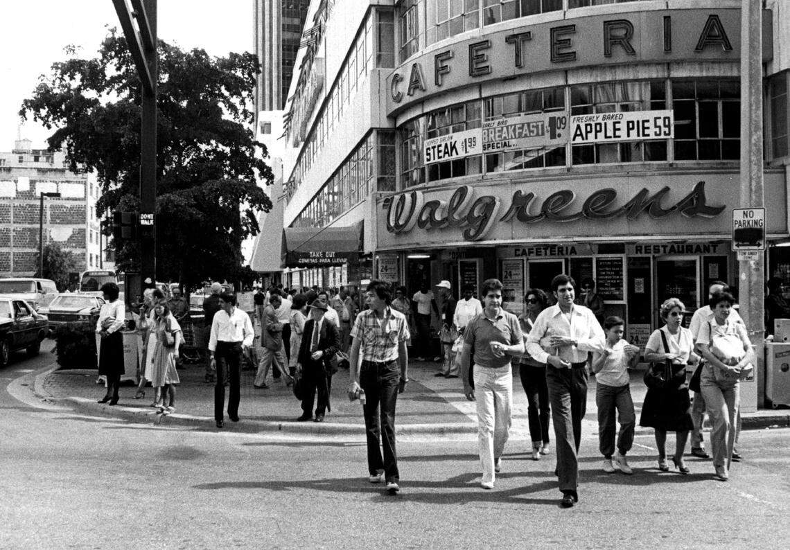 People taking a self-guided tour in downtown Miami along Flagler Street.