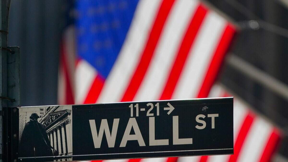 On Wednesday, Oct. 14, 2020, the American flag hangs outside the New York Stock Exchange in New York. Despite the economic and political uncertainty, investors expect profits to pop in 2021.