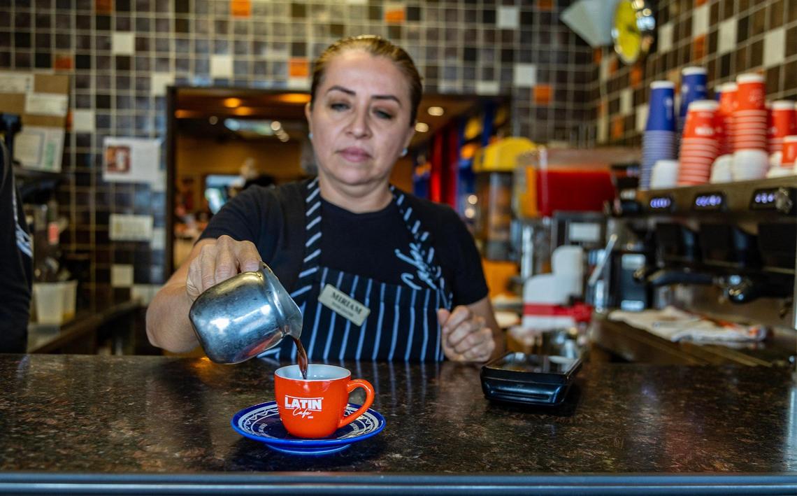Waitress Miriam Ascencio serves a Cuban cafecito at la ventanita in the Latin Cafe 2000 in Miami.