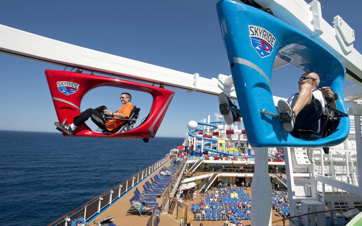 Guests aboard the Carnival Horizon pedal SkyRide vehicles around much of the 133,500-ton cruise liner.