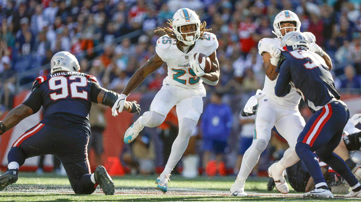 Miami Dolphins running back Jaylen Wright (25) on a carry against the New England Patriots in the second half of their NFL football game at Gillette Stadium in Foxborough, Massachusetts on Sunday, October 6, 2024.