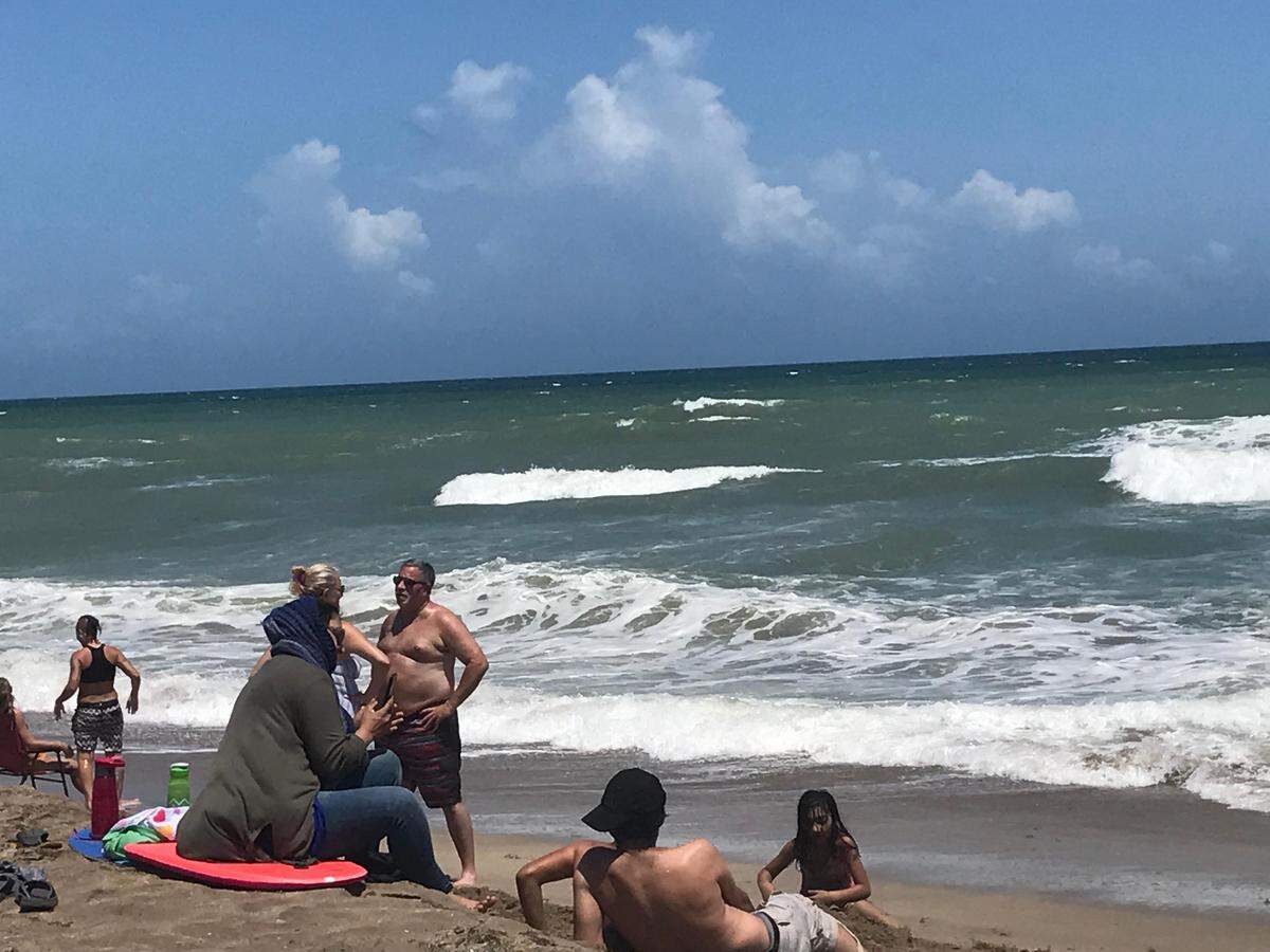 People gather on Stuart Beach on Sunday, Sept. 1, 2019, ahead of Hurricane Dorian.
