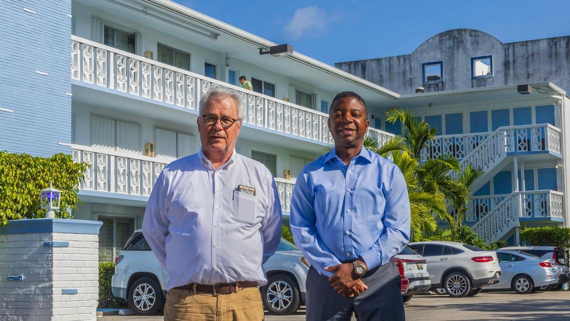Manager Heri Kletzenbuer, left, and board president Andre Williams stand outside the Golden Key Condominiums in Bay Harbor Islands. The managers of the modest 1960s condo have maintained affordability for owners while extensively refurbishing the building and successfully navigating recertification and stringent new post-Surfside state regulations.