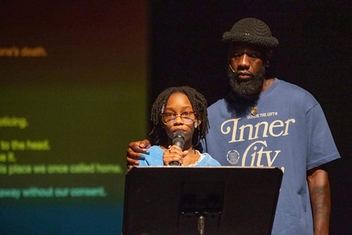 Roscoè B. Thické III and his daughter, Jada. She is reciting her original poem, “Grief.”