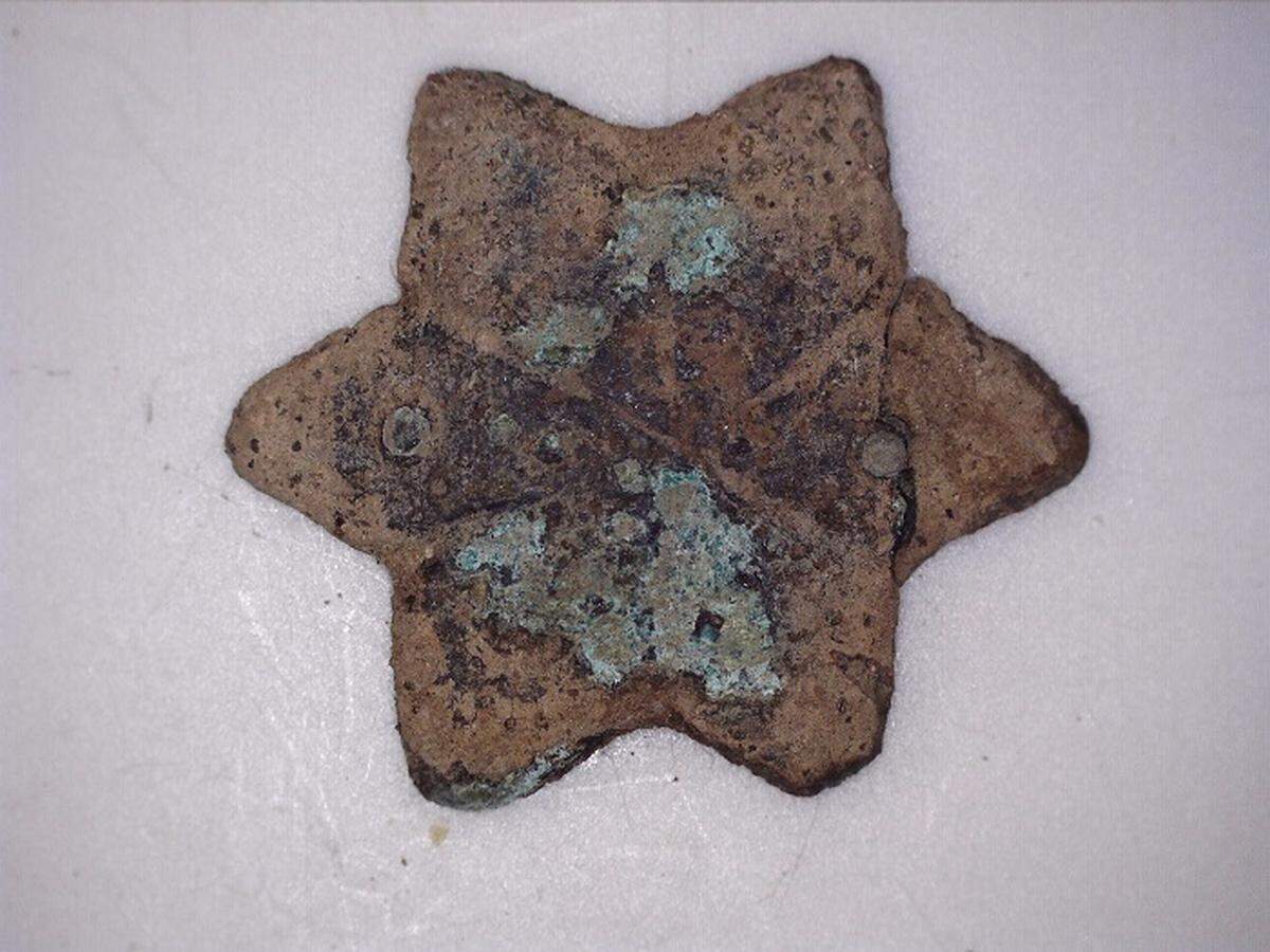 Part of a copper belt found at the site.
