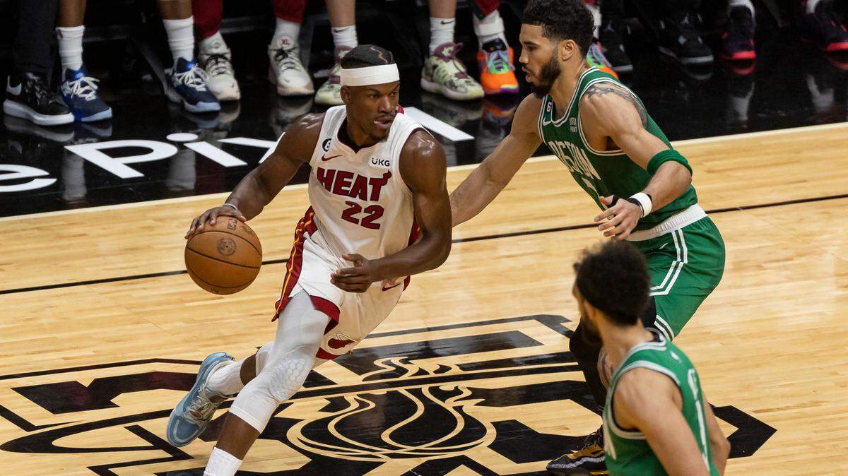 Miami Heat forward Jimmy Butler (22) drives with the ball as Boston Celtics forward Jayson Tatum (0) defends during the third quarter in Game 6 of the NBA Eastern Conference Finals at the Kaseya Center on Saturday, May 27, 2023, in downtown Miami, Fla.