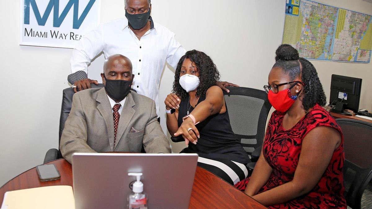 An MLS, or Multiple Listing Service, is a cooperative database of houses for sale in a local or regional market. Above: Tiffany and Reginald Offord work with real estate agent Robert Henry at Miami Way Realty in Miami, Florida, July 10, 2020.